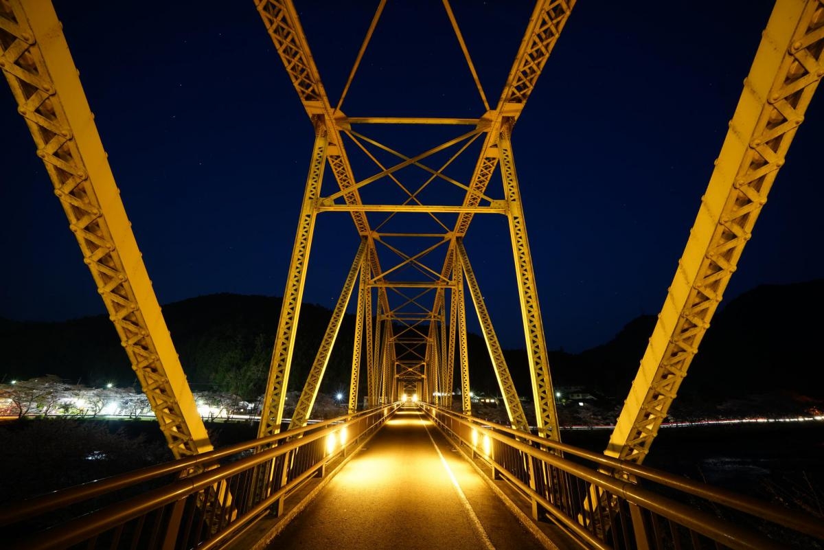 Shot along road deck of cantilever bridge at night