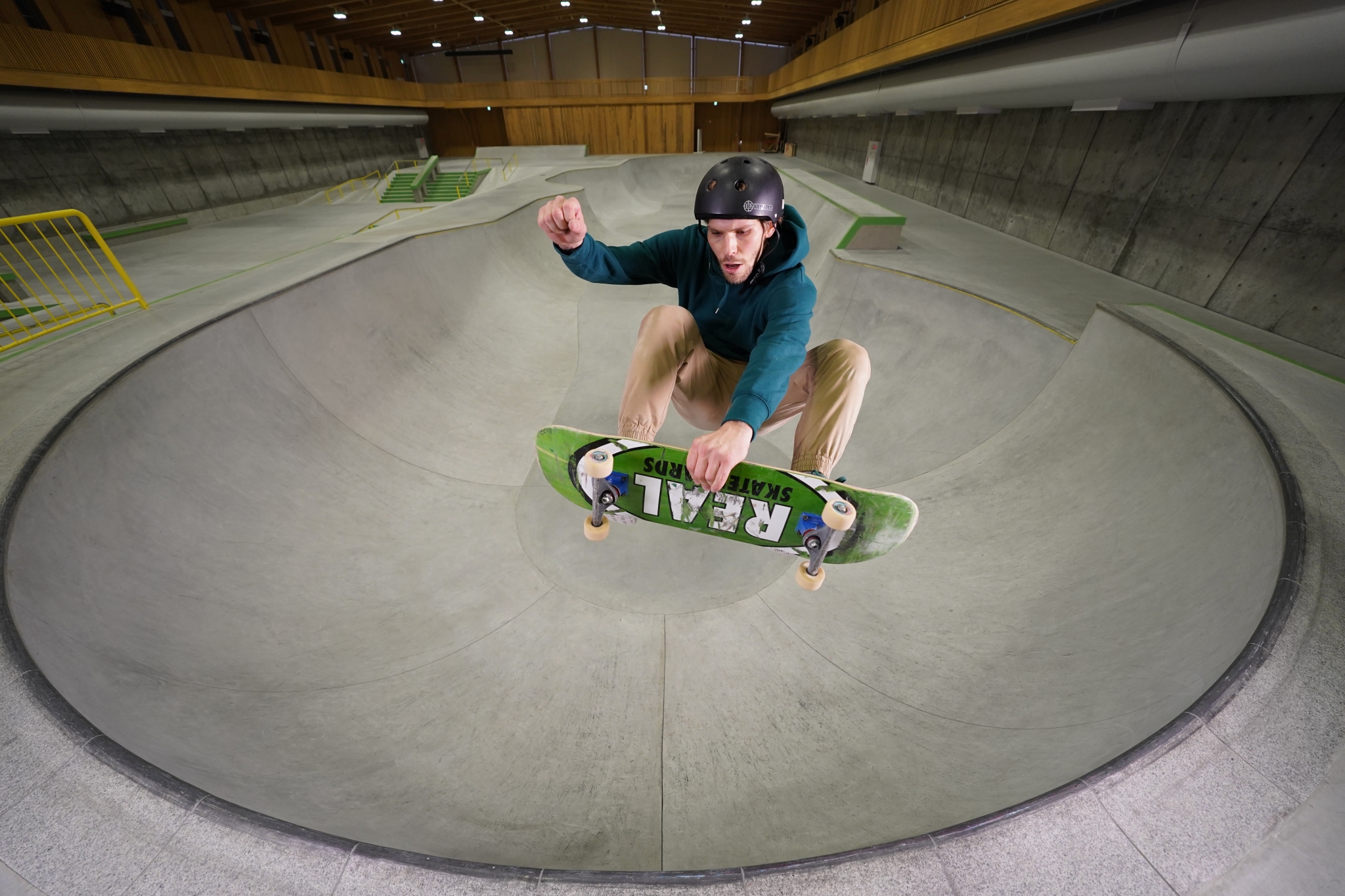 Male skateboarder performing a jump in a skateboard park