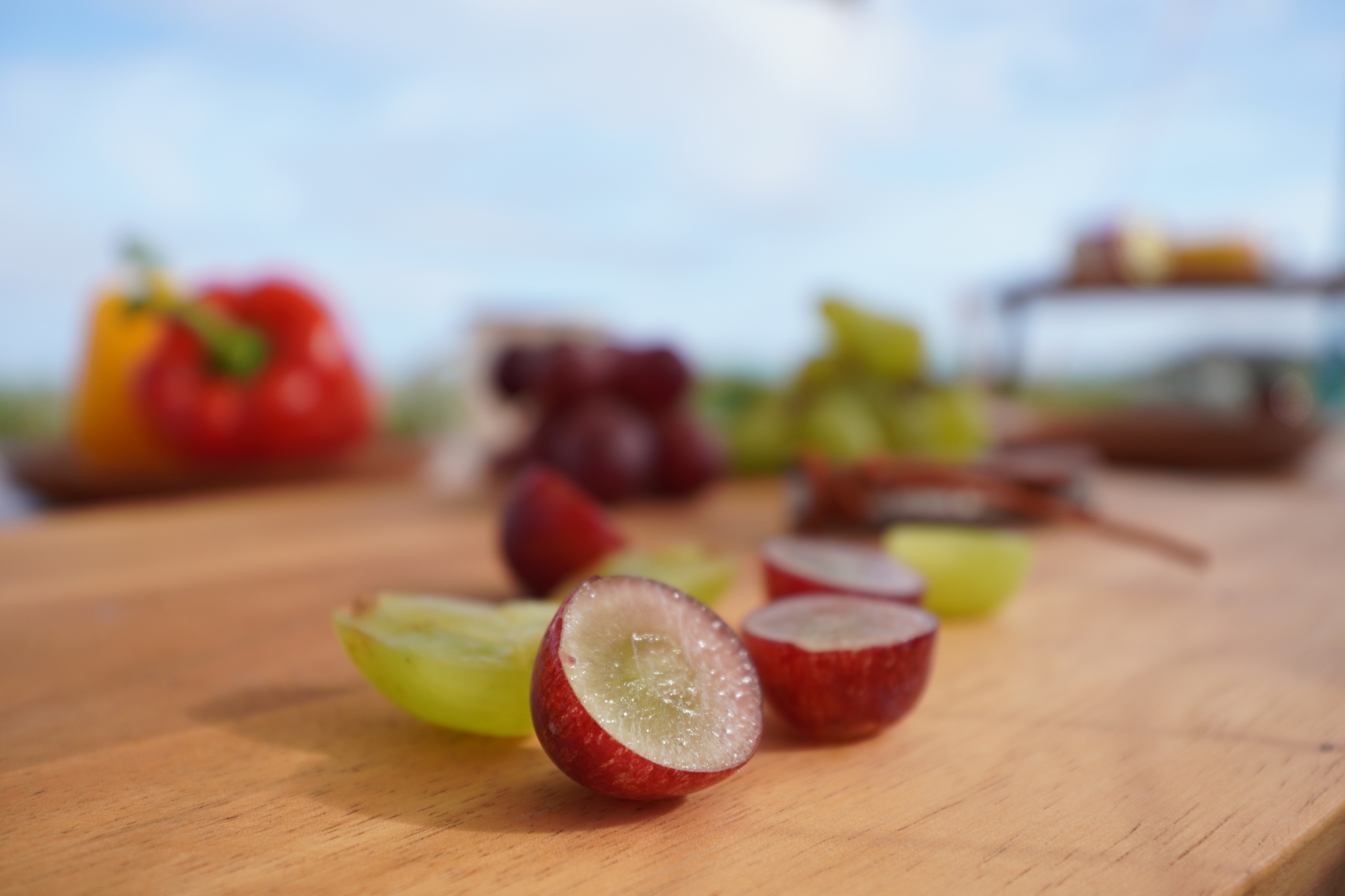 Slices grapes with other fruits in bokeh background