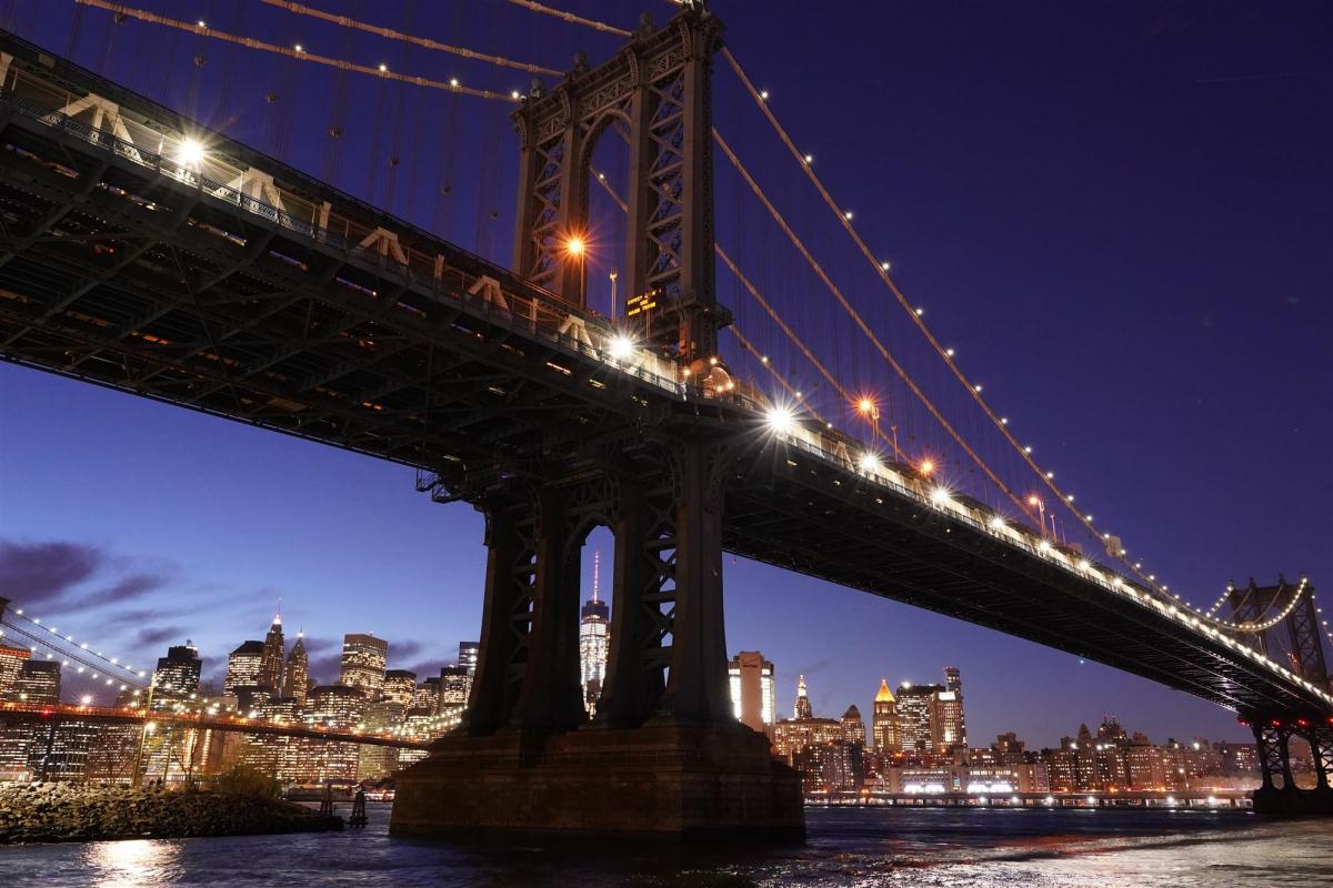 Suspension bridge (Manhattan Bridge, New York) against nocturnal cityscape
