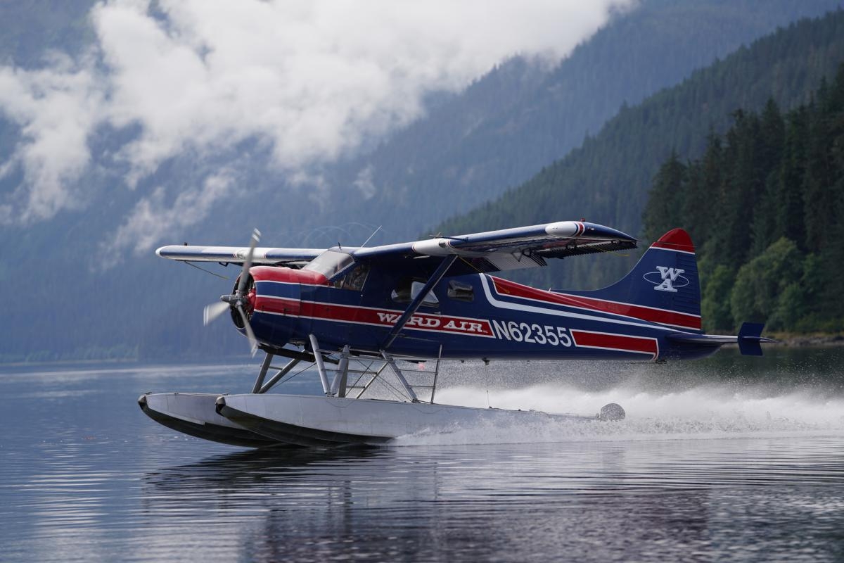 Glider plane landing on a lake