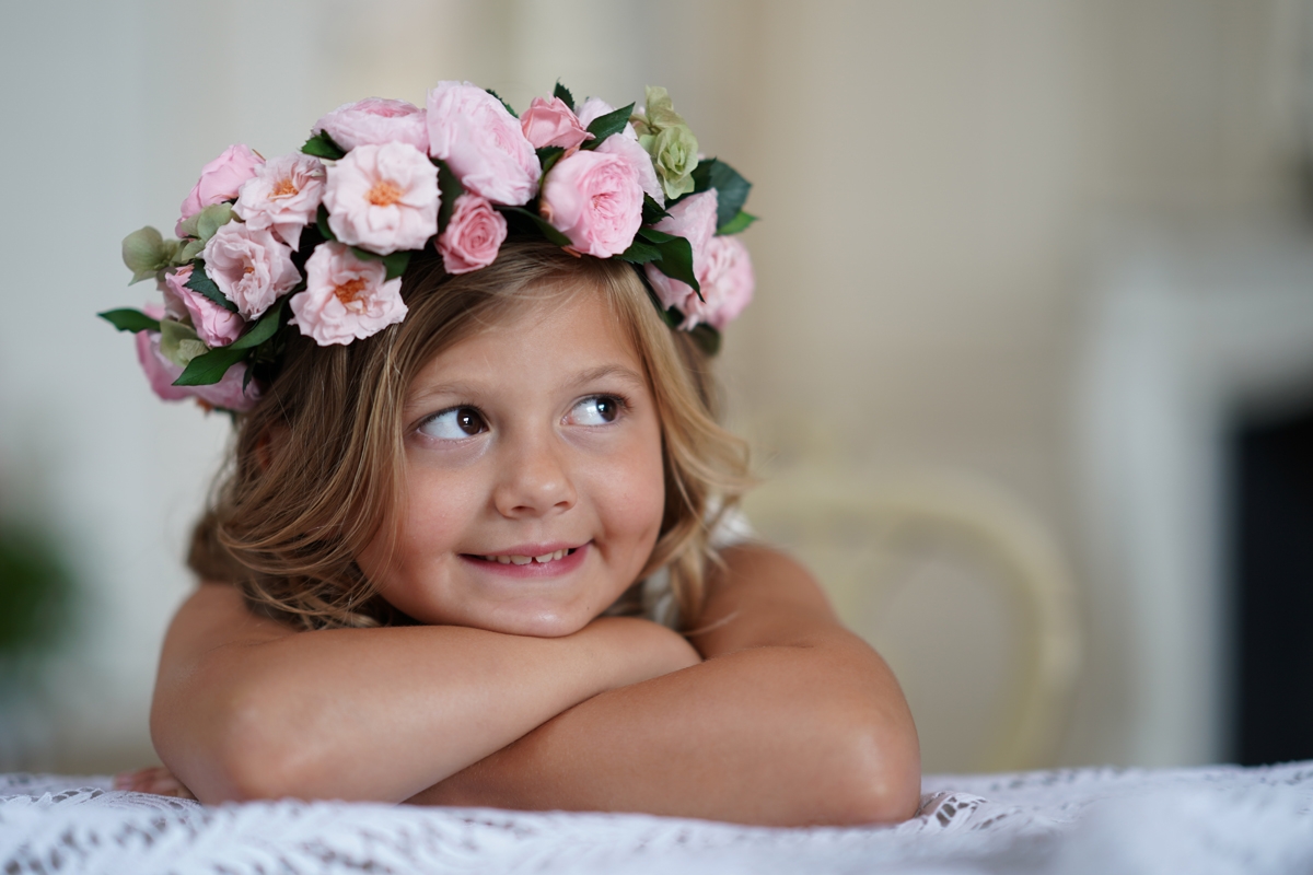 Portrait of young girl wearing a garland of pink flowers