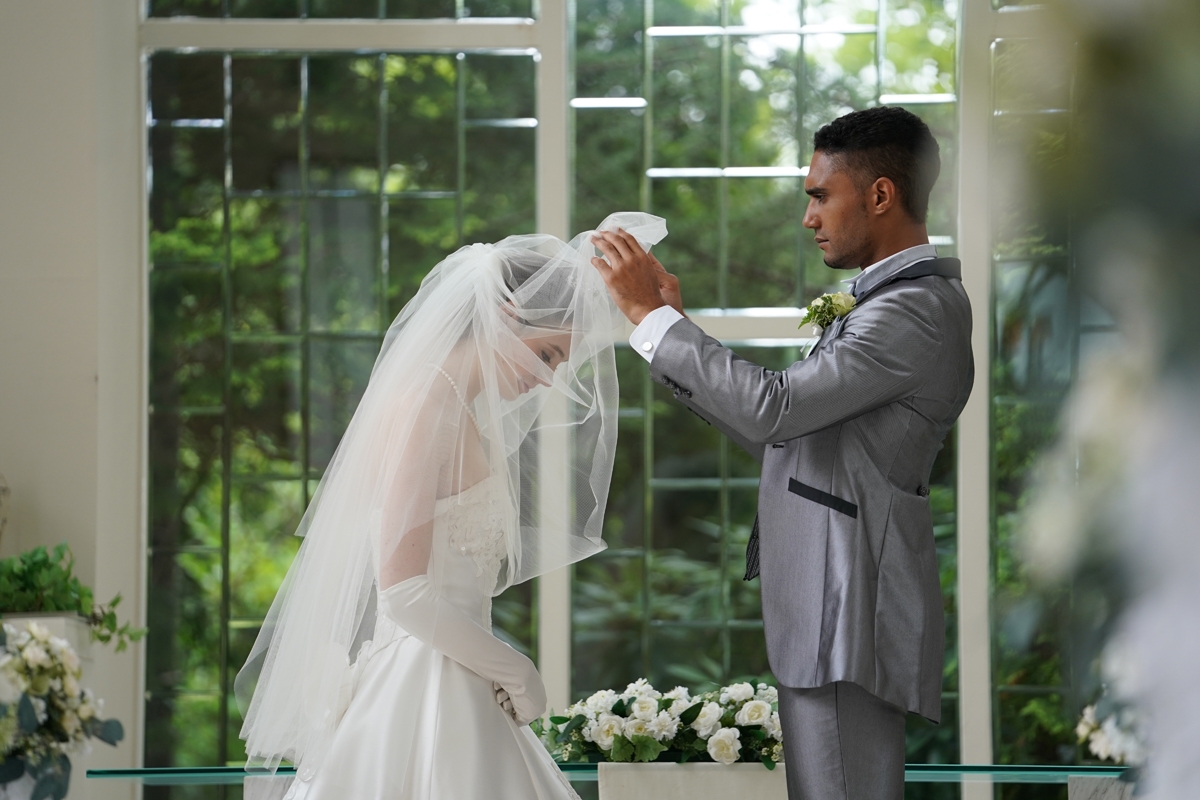 Groom lifting the veil of bride during a wedding ceremony