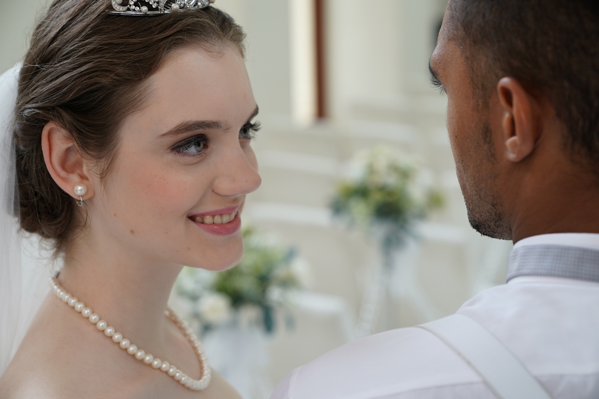Close-up of bride smiling at groom