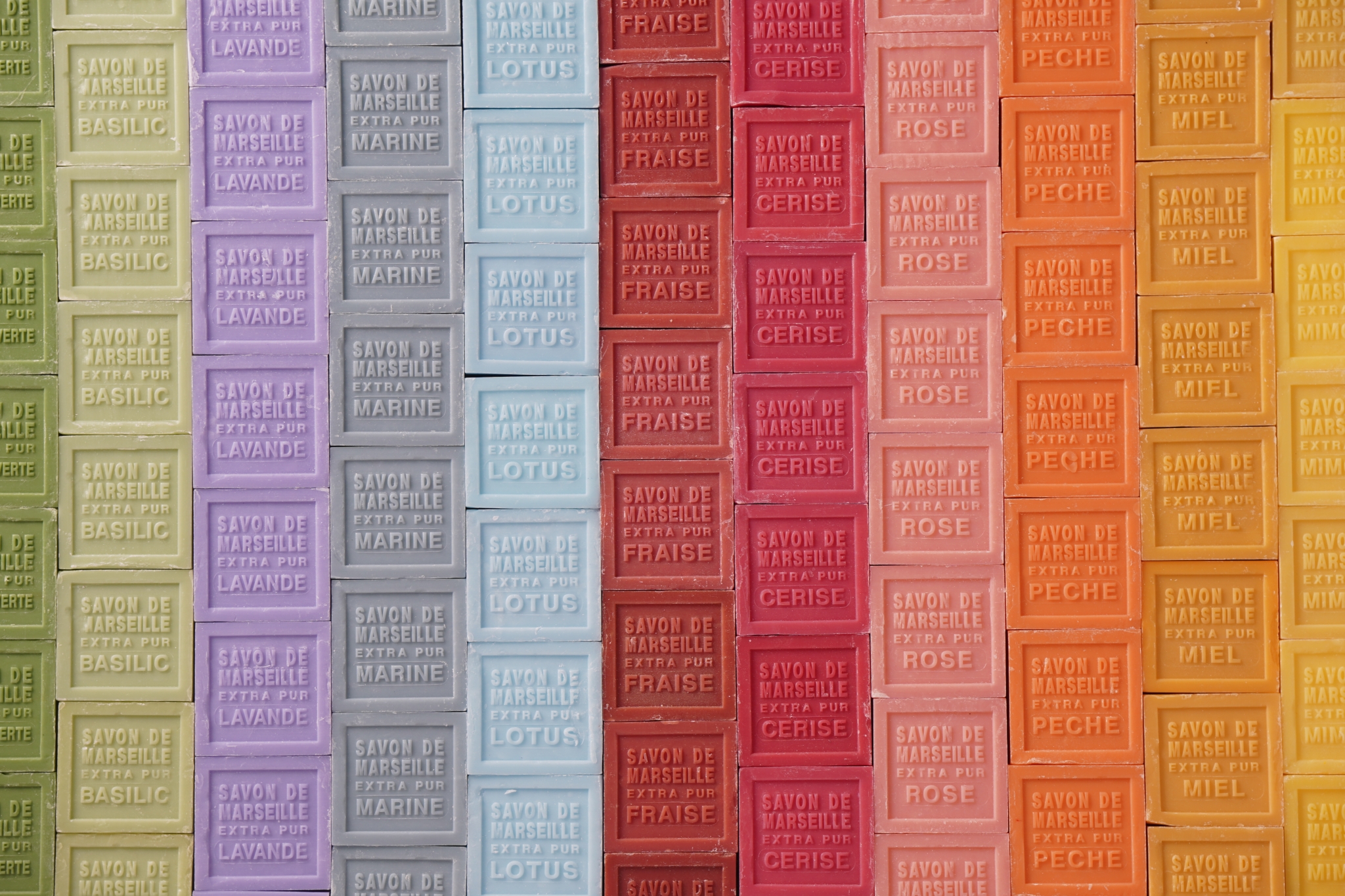 Bars of soap arranged in rows by colour