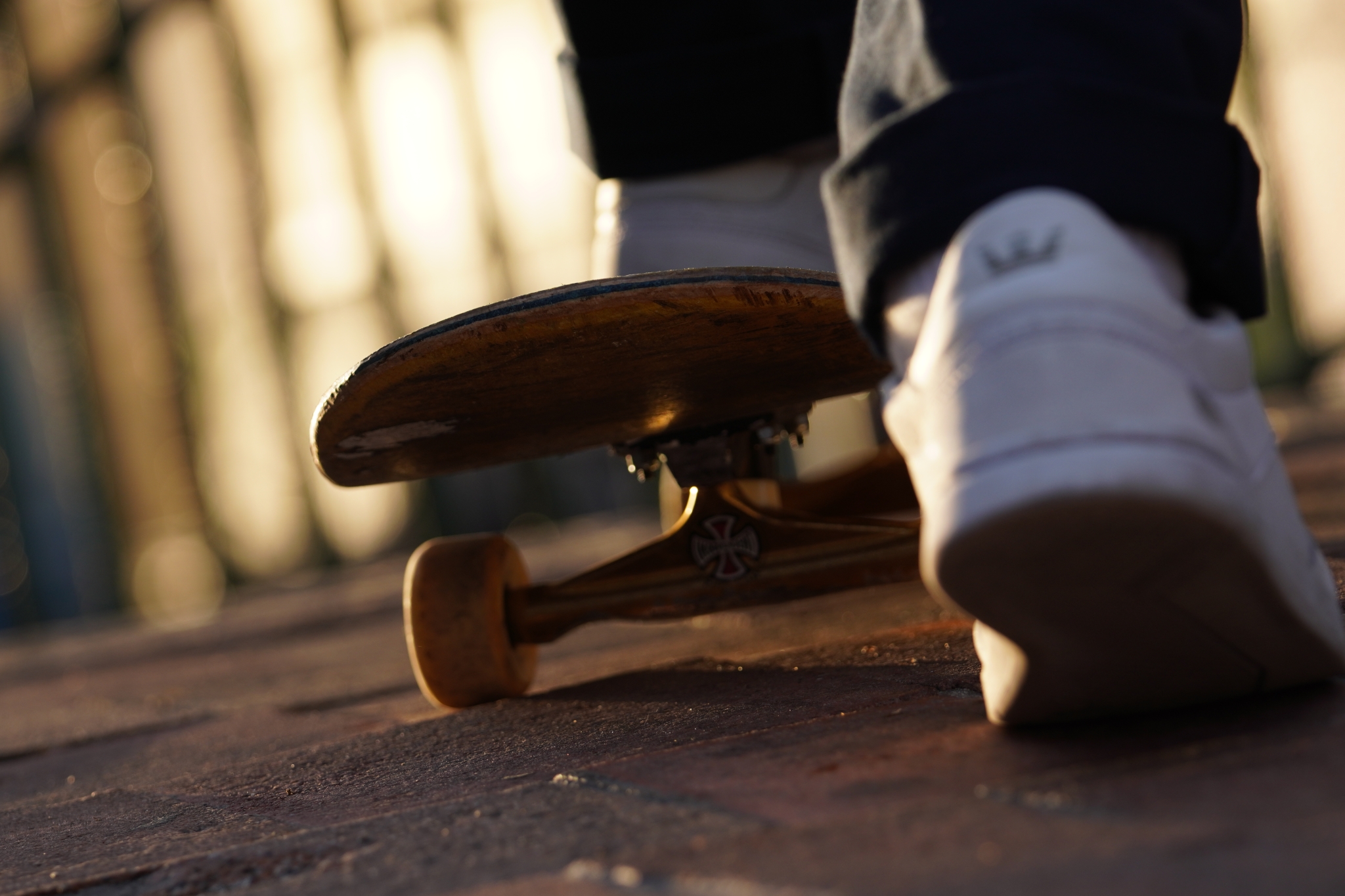 Close-up on of skateboarder's feet, one on the board, one about to push