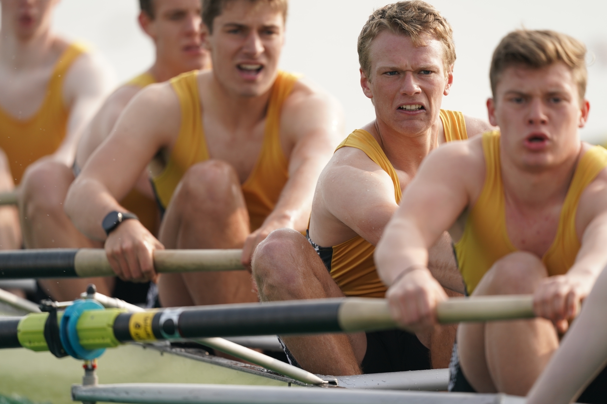 Close-up of male rowers in a boat