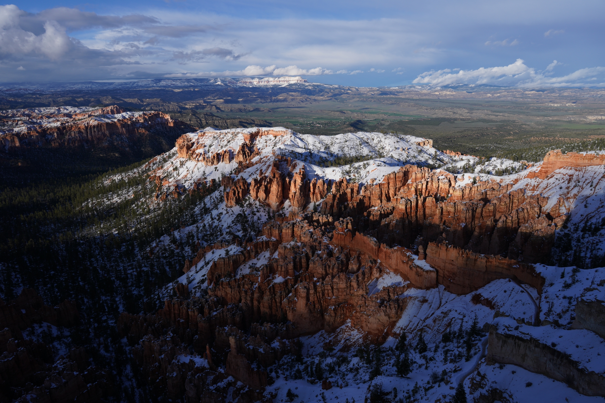 Landscape of red rocky cliffs dusted with snow