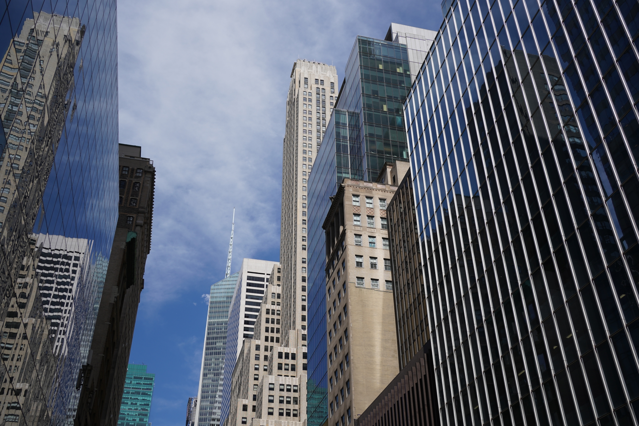 Upwards shot of skyscrapers against a blue sky