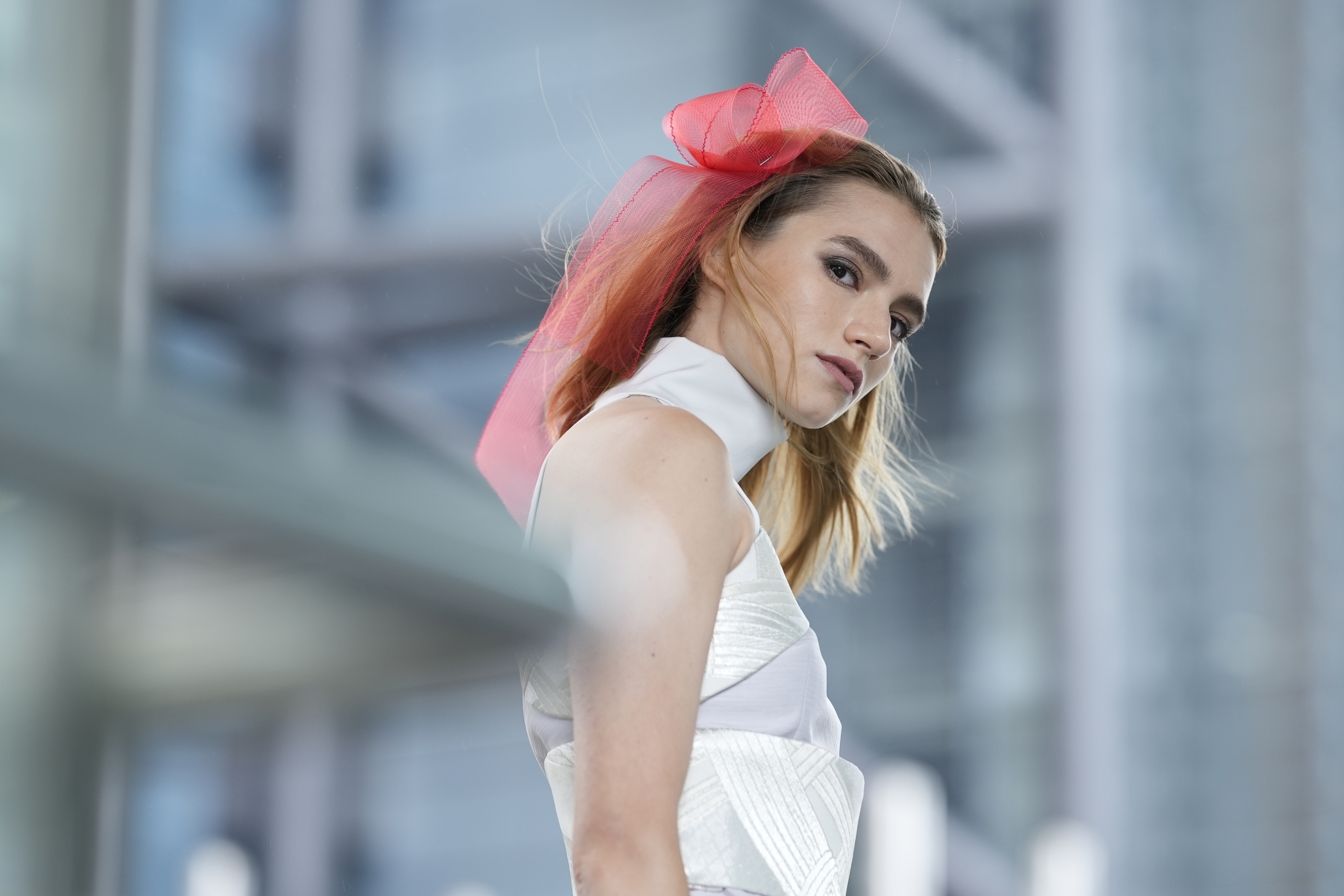 Female model with ribbon in her hair with deep bokeh foreground and background