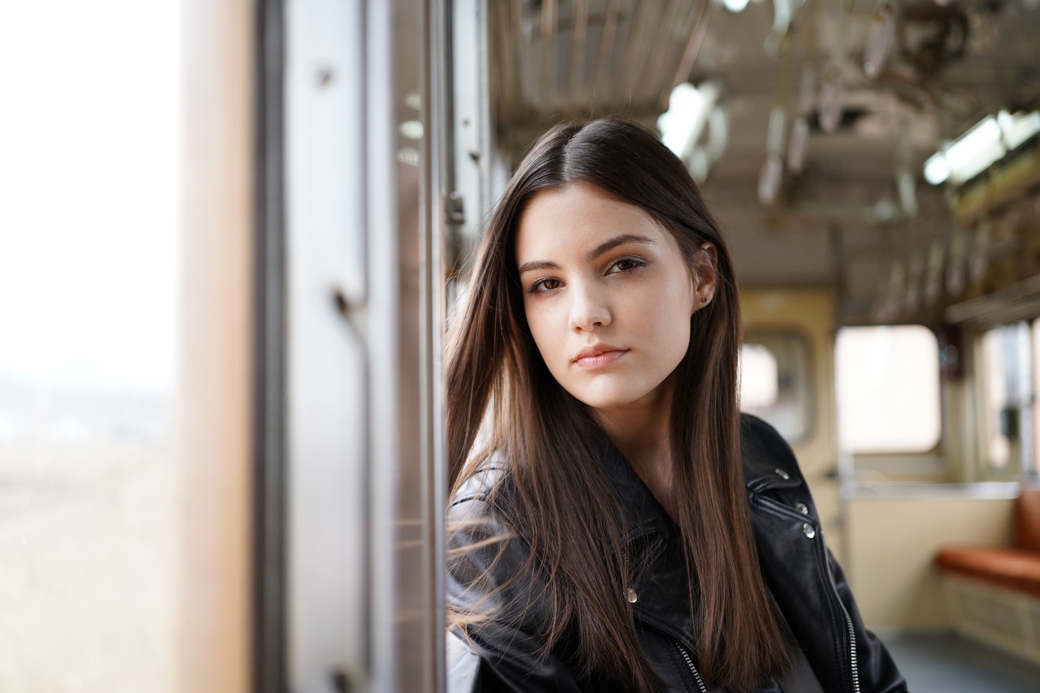Portrait of female model riding a train