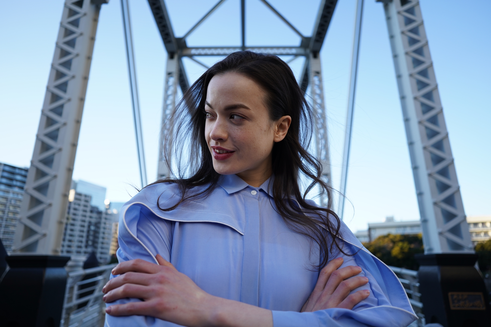 Portrait of female model in the centre of a suspension bridge