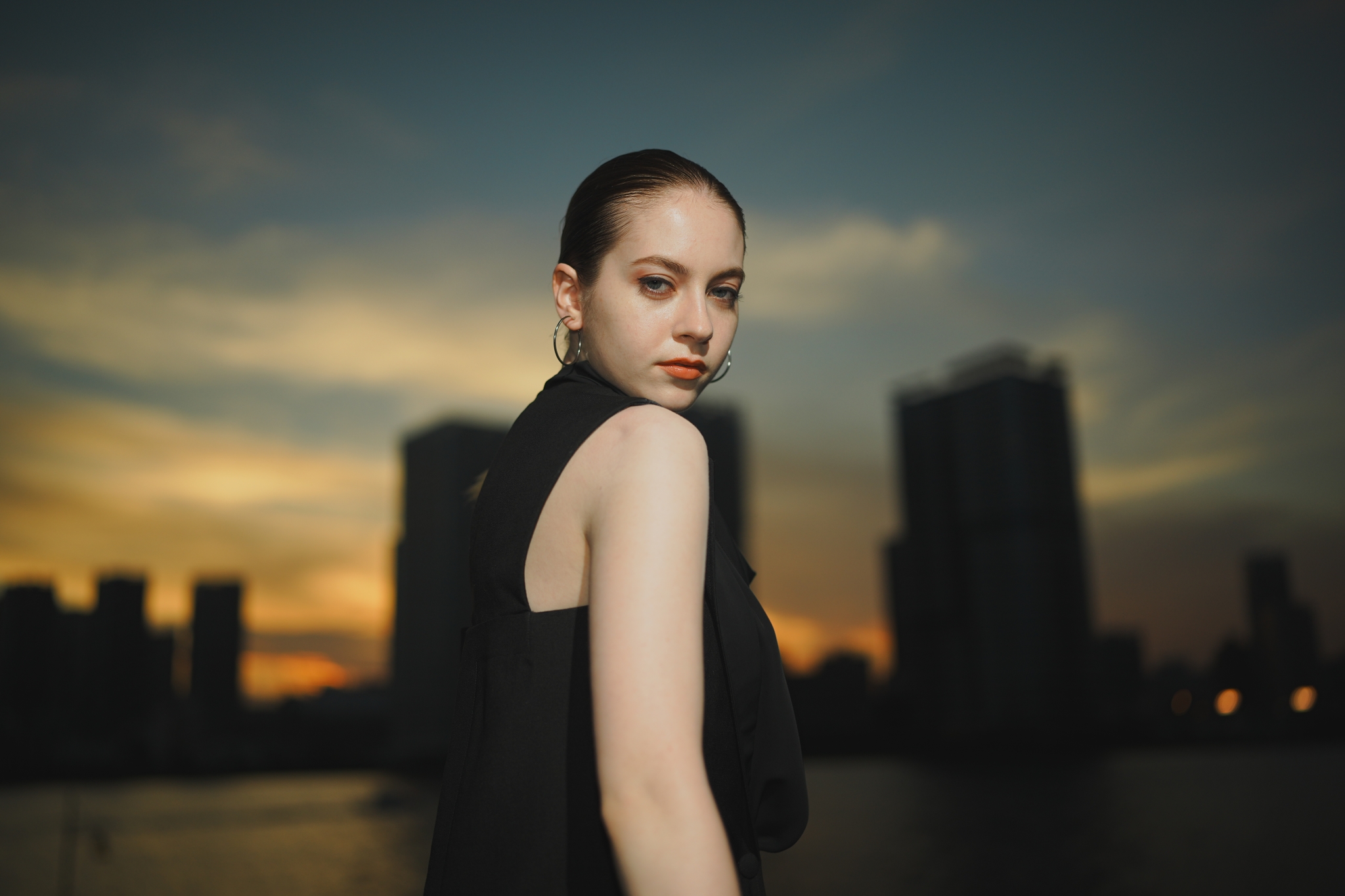 Female model with sunset cityscape in the background