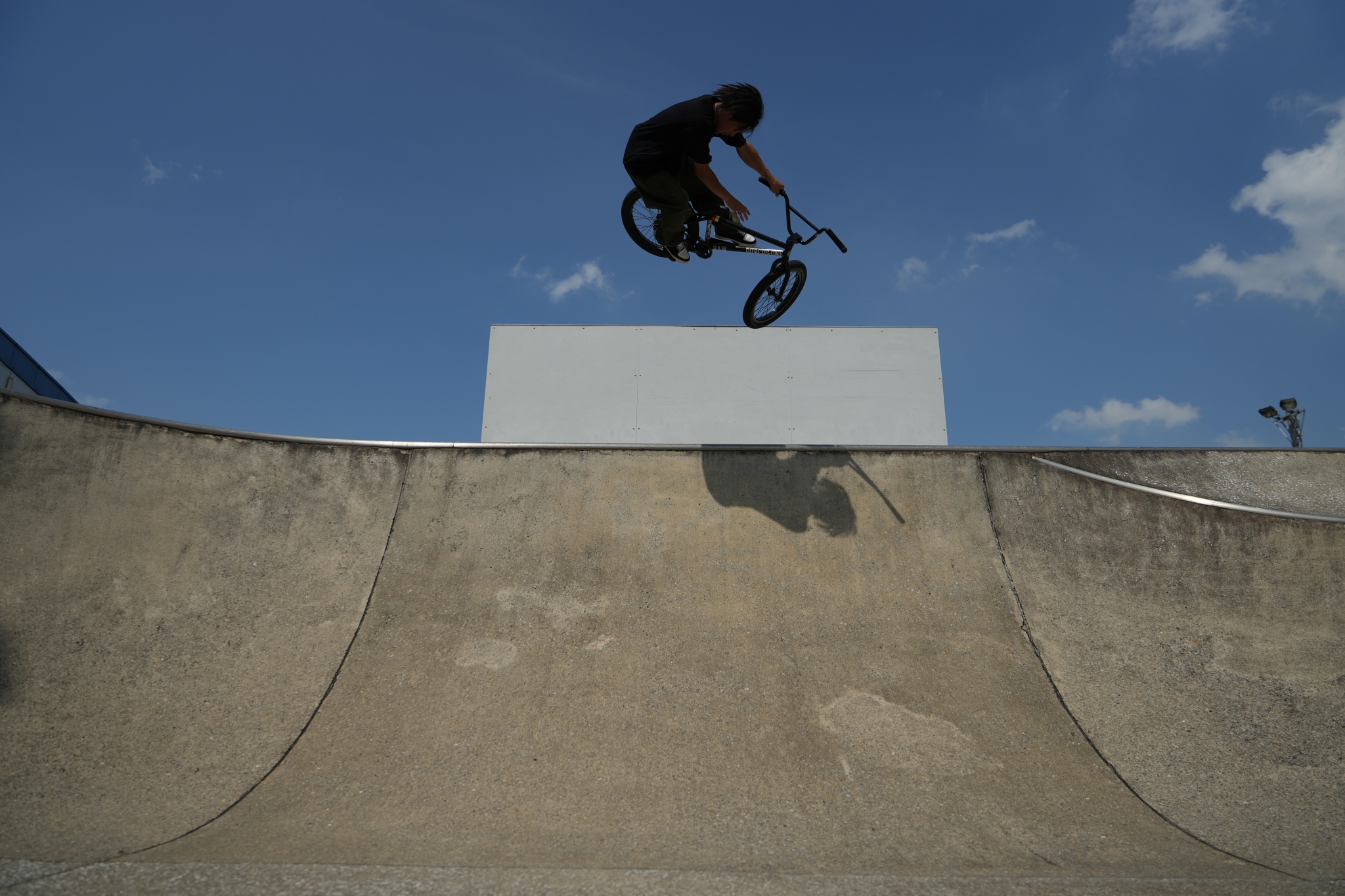 BMX rider mid-jump in a skate park