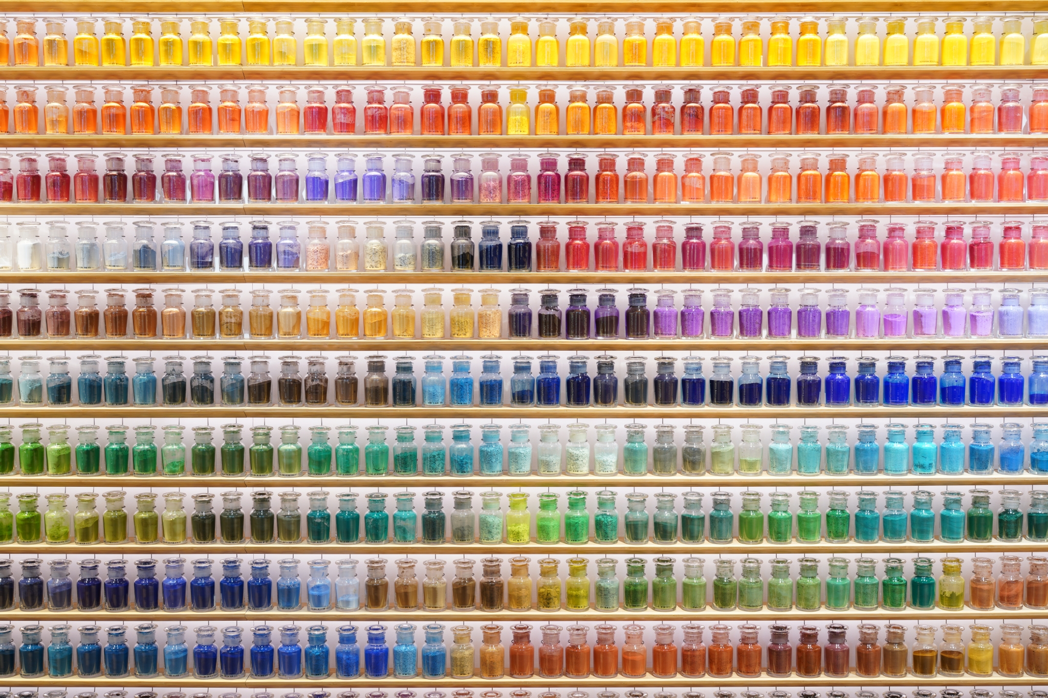 Jars of ink of various colours lined up on shelves