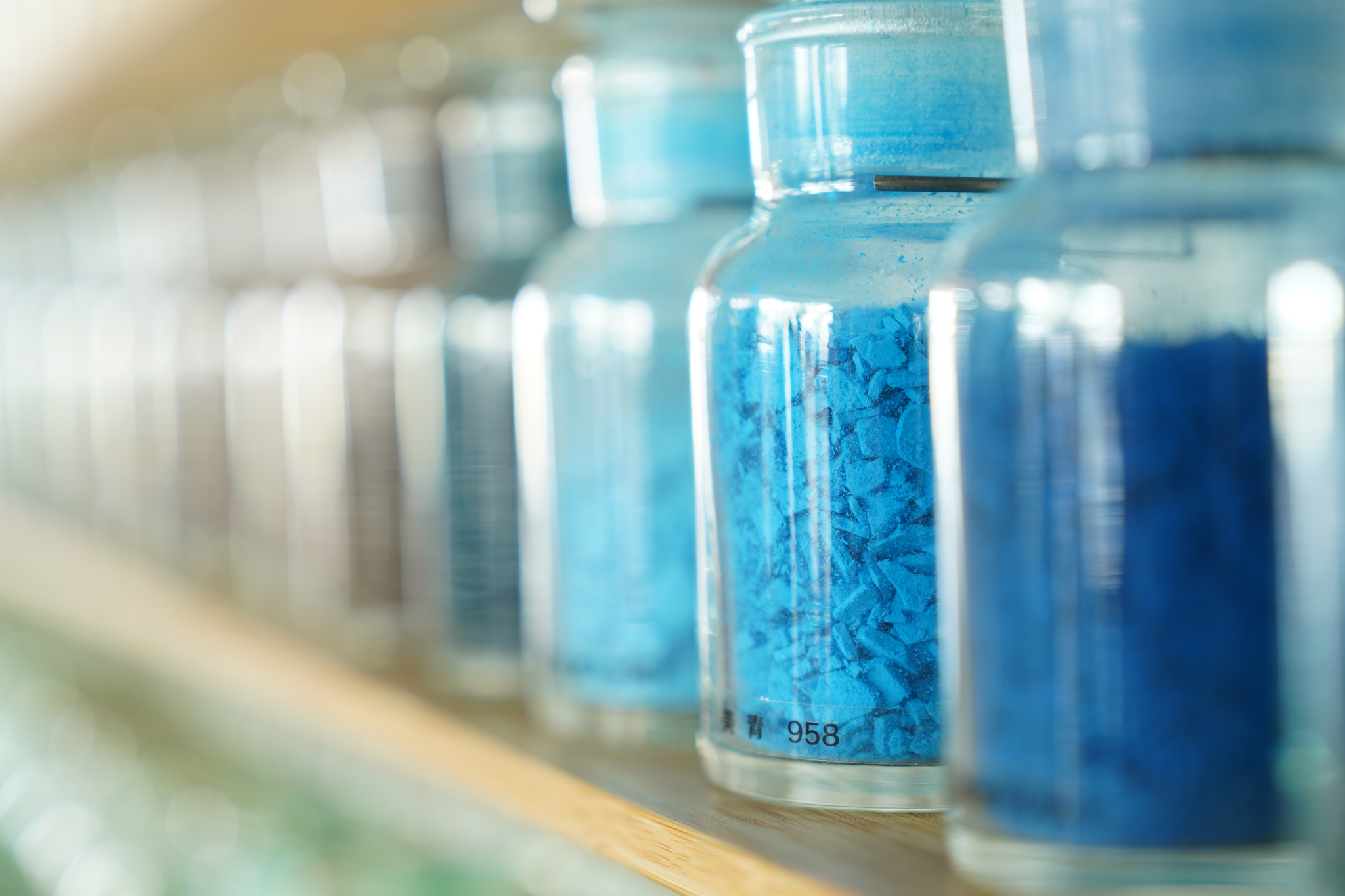 Jars of blue ink with a bokeh background
