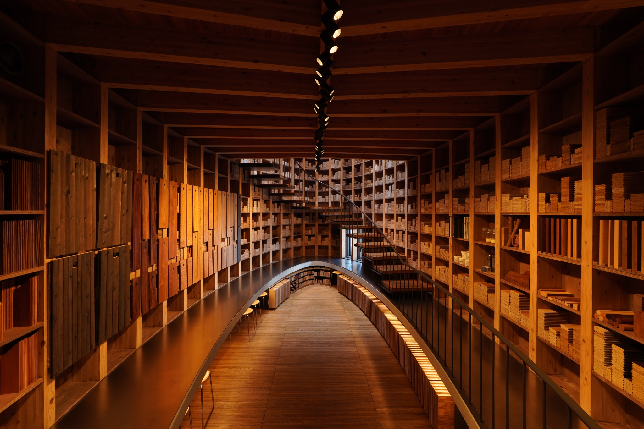 Atrium of a large library with wooden shelves and beams
