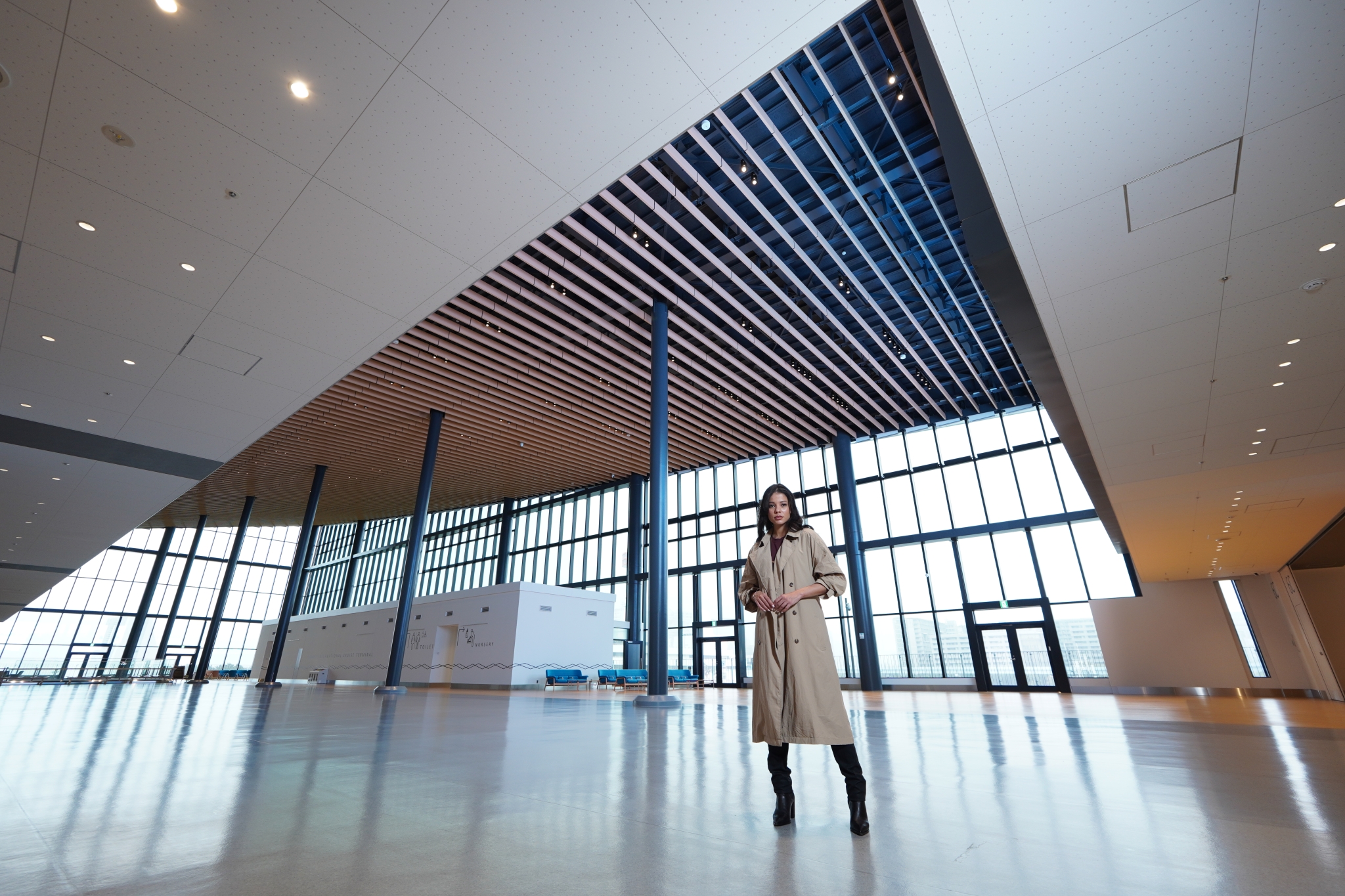 Female model in a large atrium with glass walls