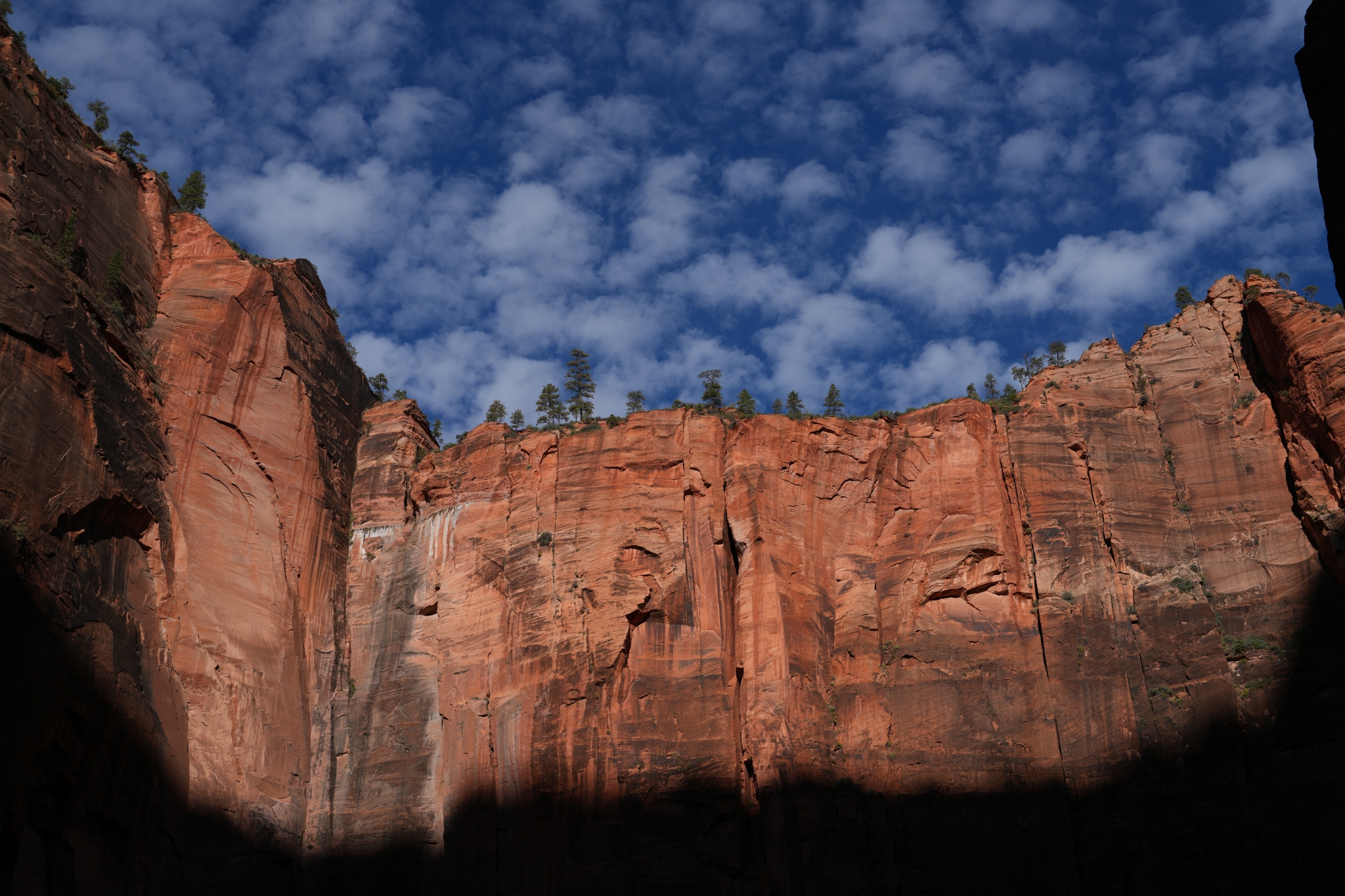 Red rocky cliffs against a deep blue sky