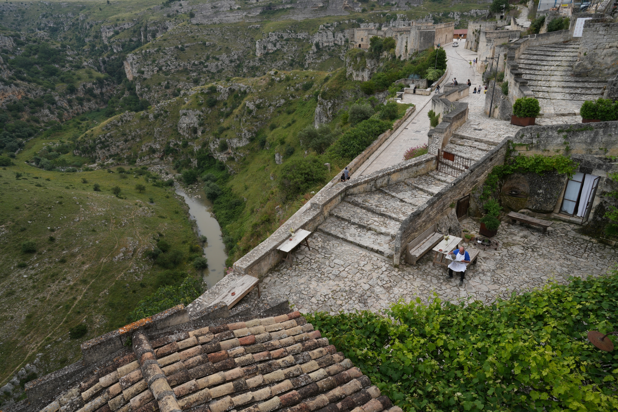 A stone-paved terrace with a view over rocky terrain
