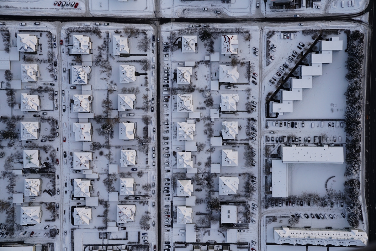 Aerial view of houses and streets covered with snow