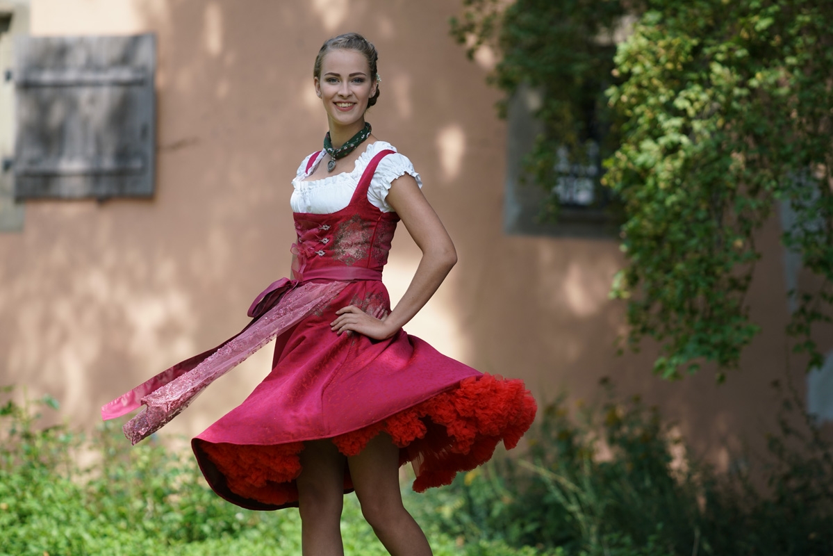 Portrait of female model twirling red skirt