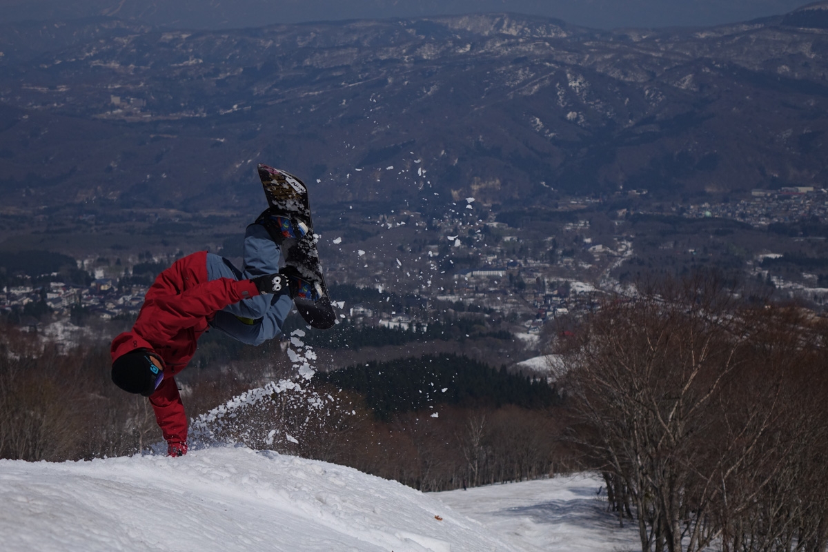Snowboarder upside down in mid-jump
