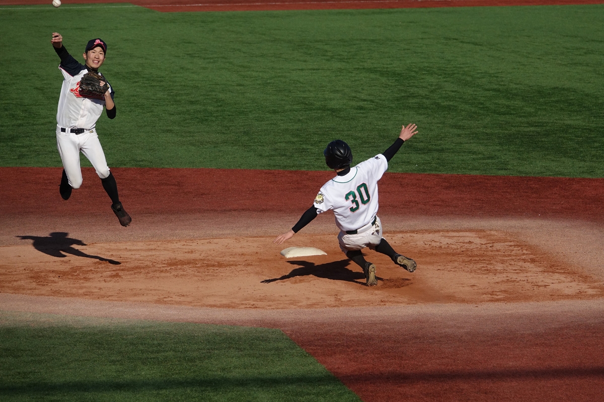Two baseball players in action