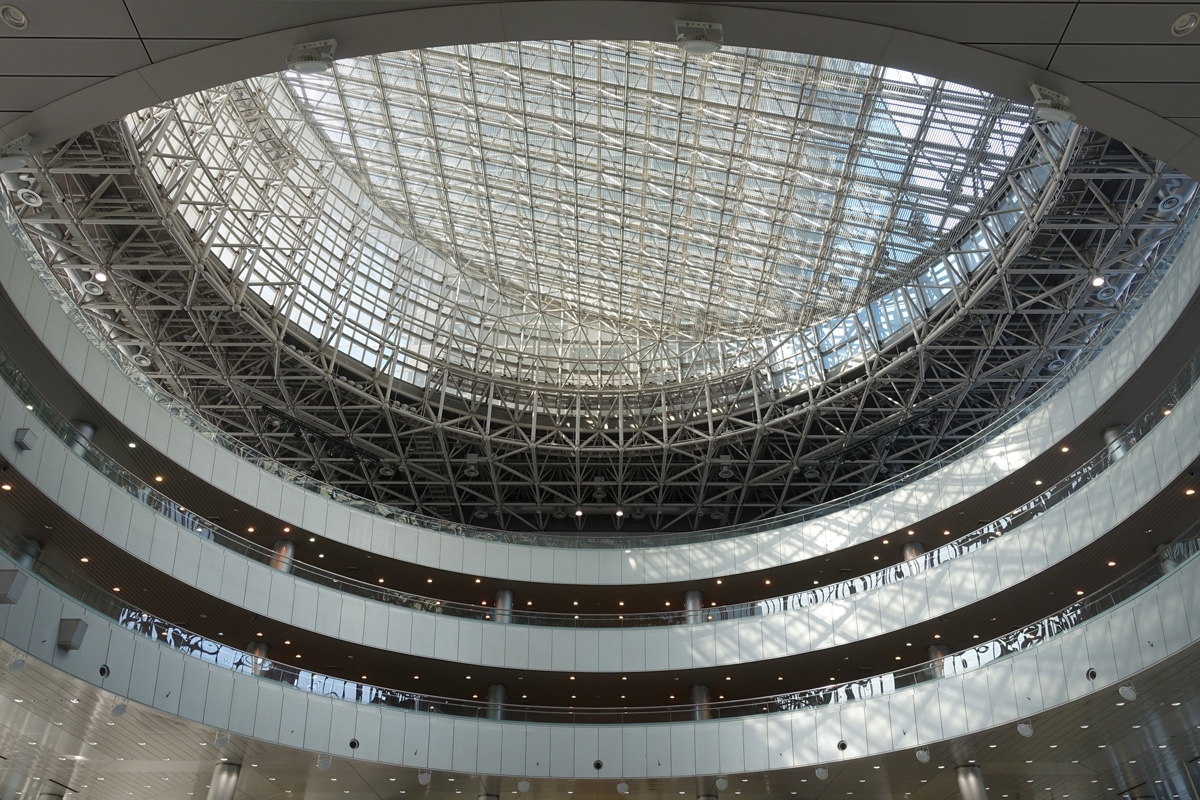 Interior of large atrium surrounded by several floors with glass roof