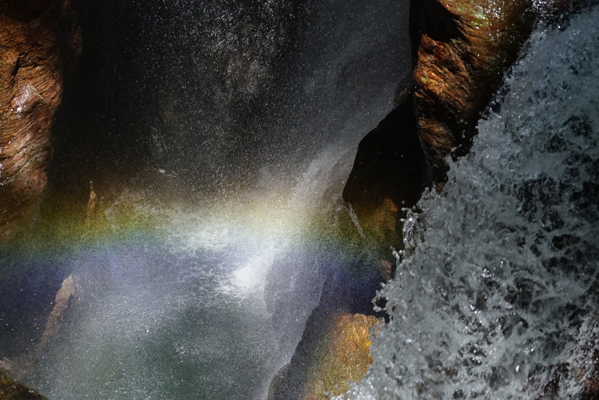View of waterfall with light creating a rainbow effect