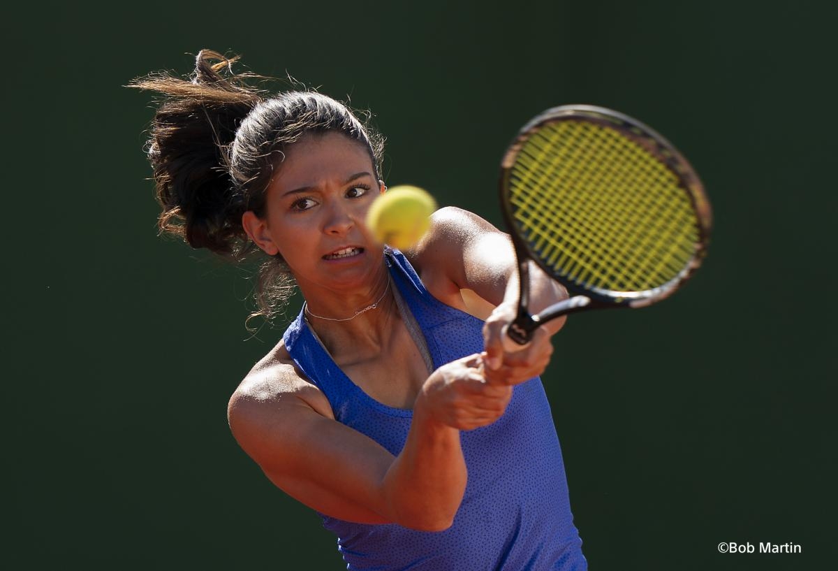 Female tennis player just after striking the ball