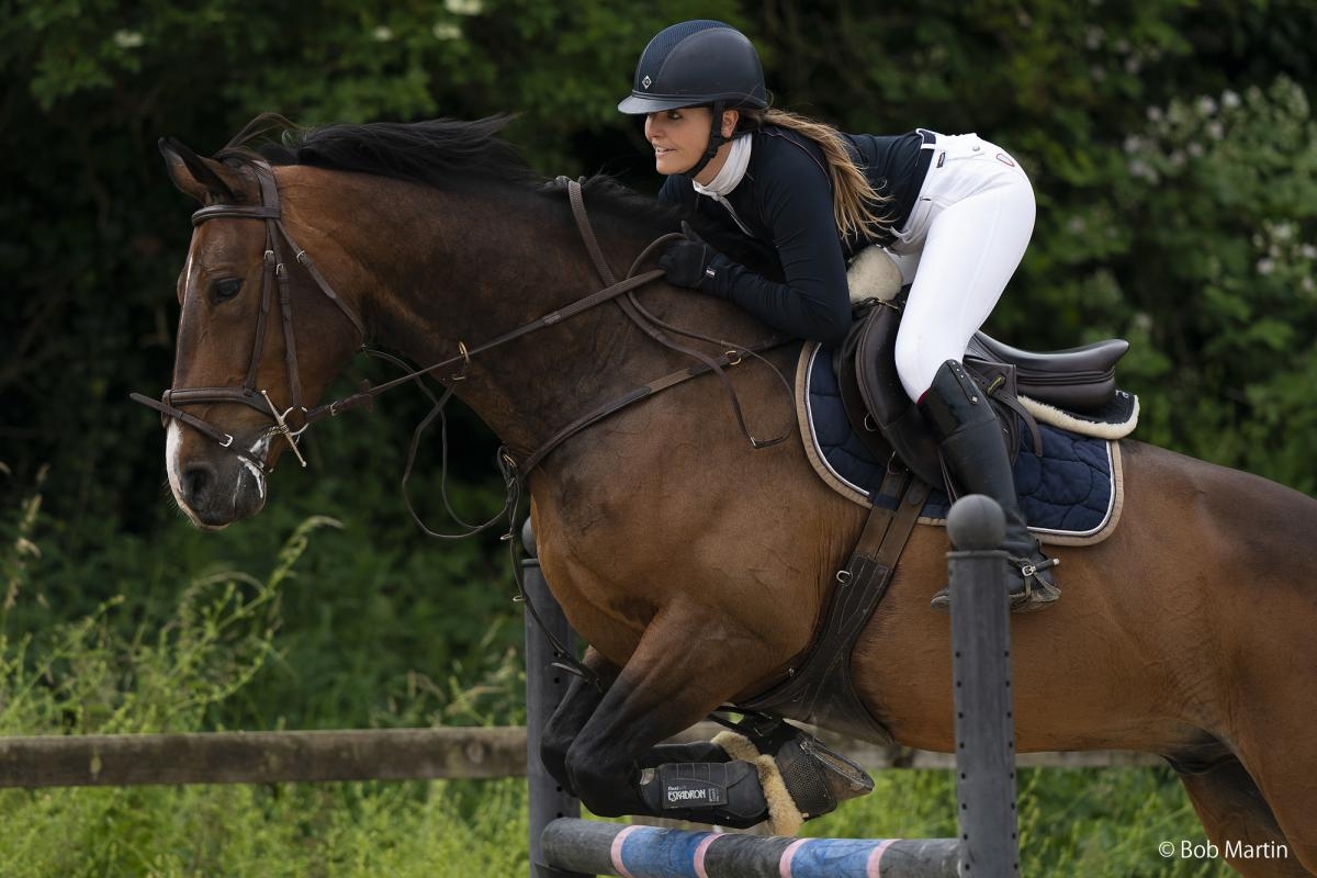 Horse and rider jumping a fence