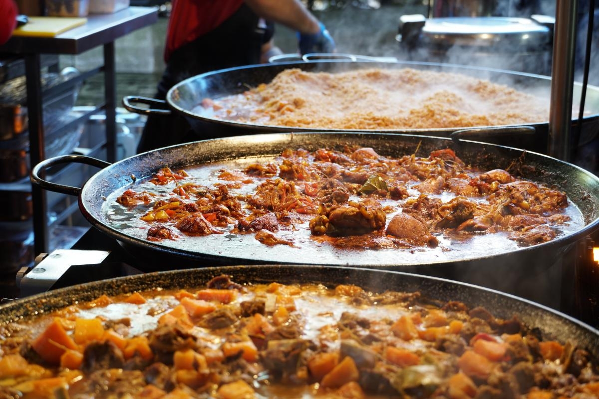 Three woks containing various dishes