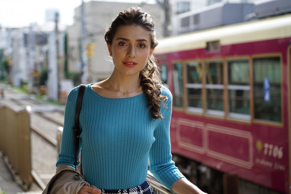 Female model with old-fashioned train the background