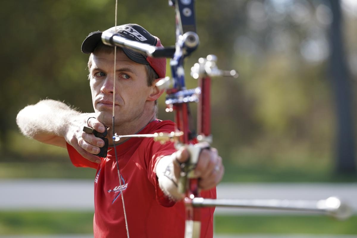 Close-up of male archer pulling back an arrow to take a shot