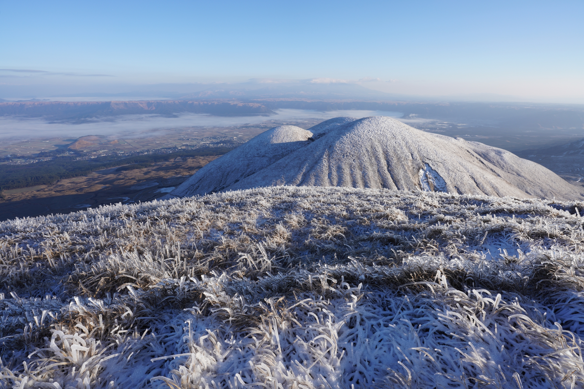 Grassy mountainous landscape covered with deep frost