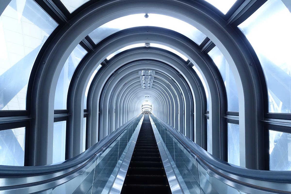 Shot looking up escalator with glass roof