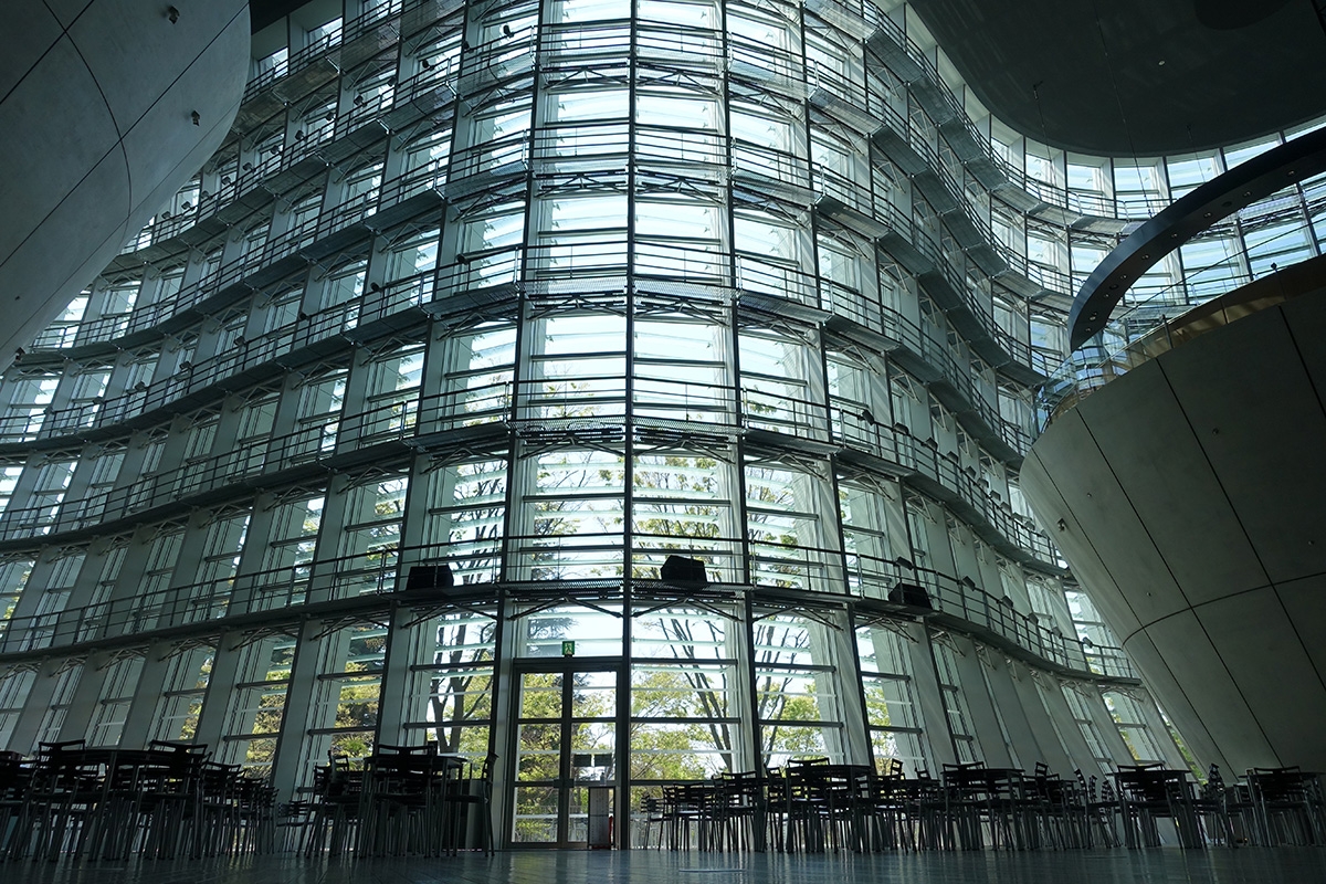 View from inside curved wall of building made largely of glass