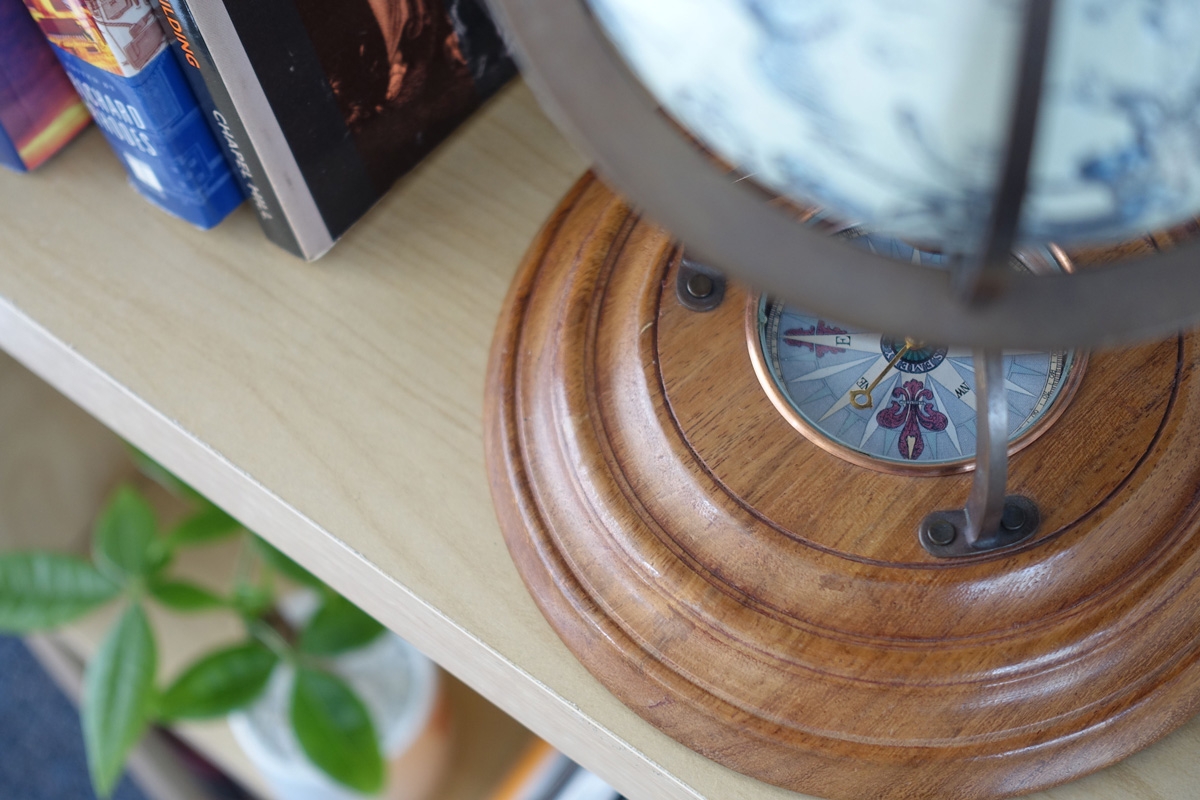 Close-up of bookshelf with books and part of lamp visible