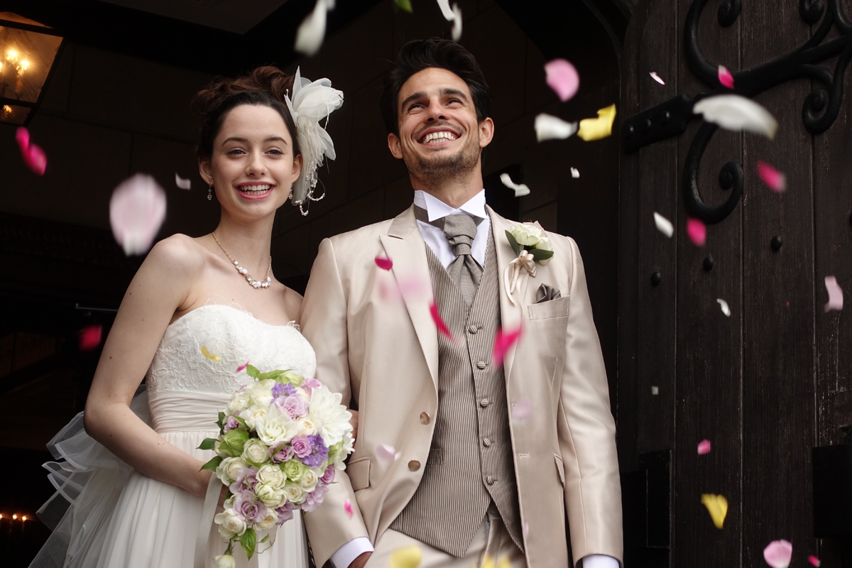 Couple on wedding day, with bride carrying bouquet