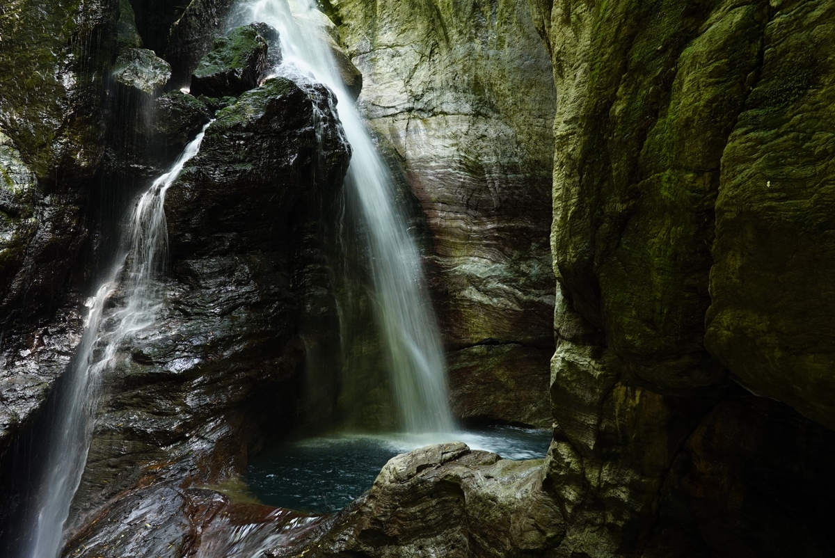 Waterfall against high rock walls