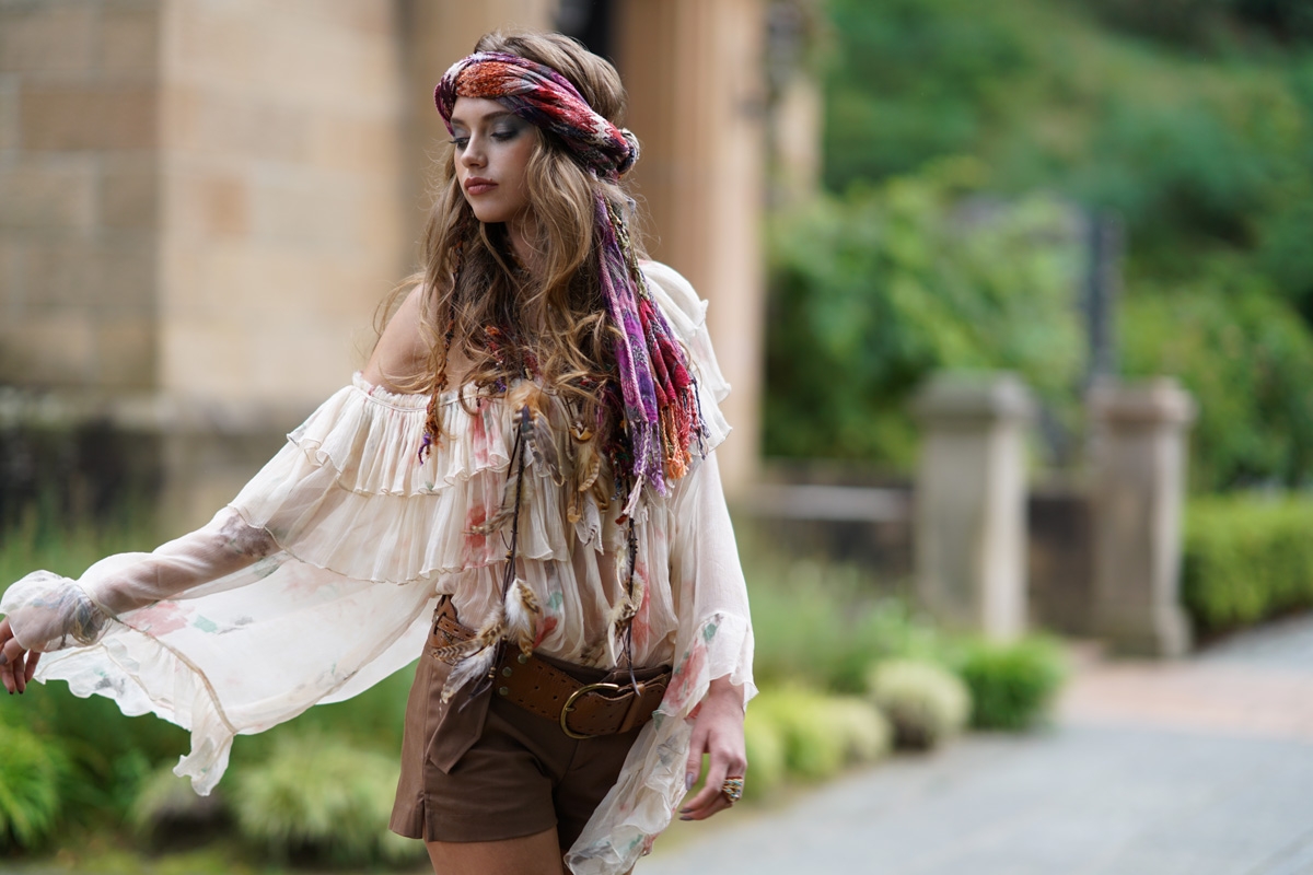 Portrait of woman with woollen hat and scarf, with some background bokeh