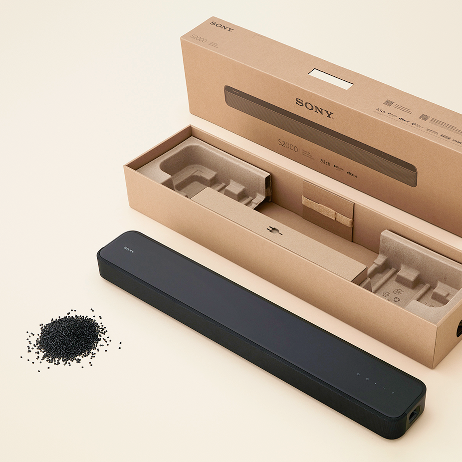 Image of a soundbar, its paper packaging materials, and a pile of plastic pellets.